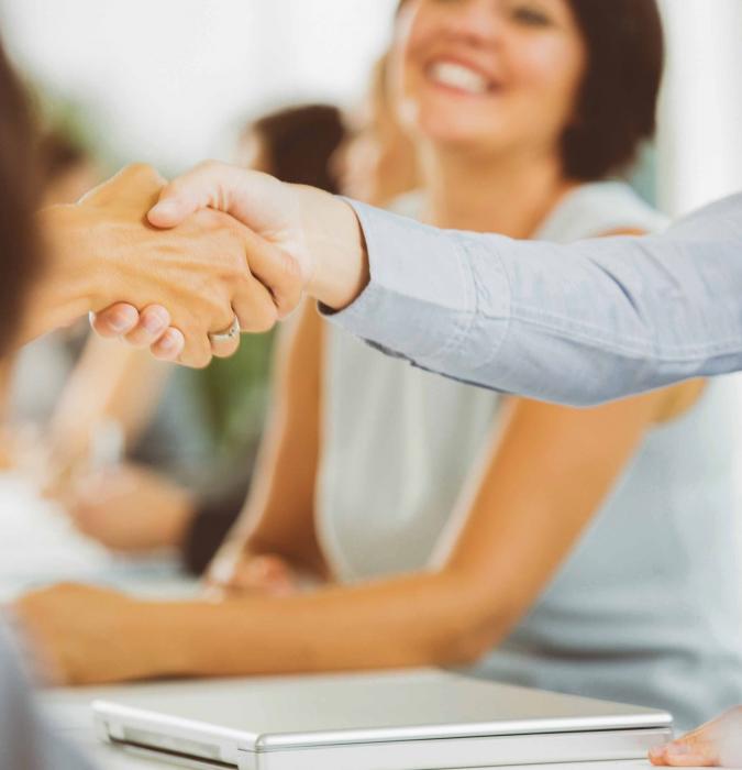 Caregiver and Patient in office shaking hands