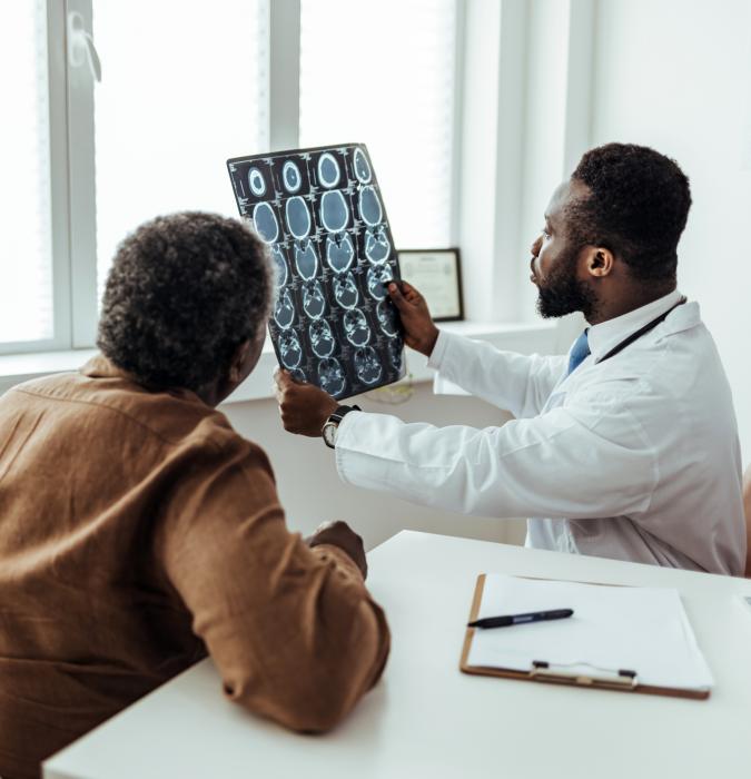 Caregiver explaining brain scans to a patient