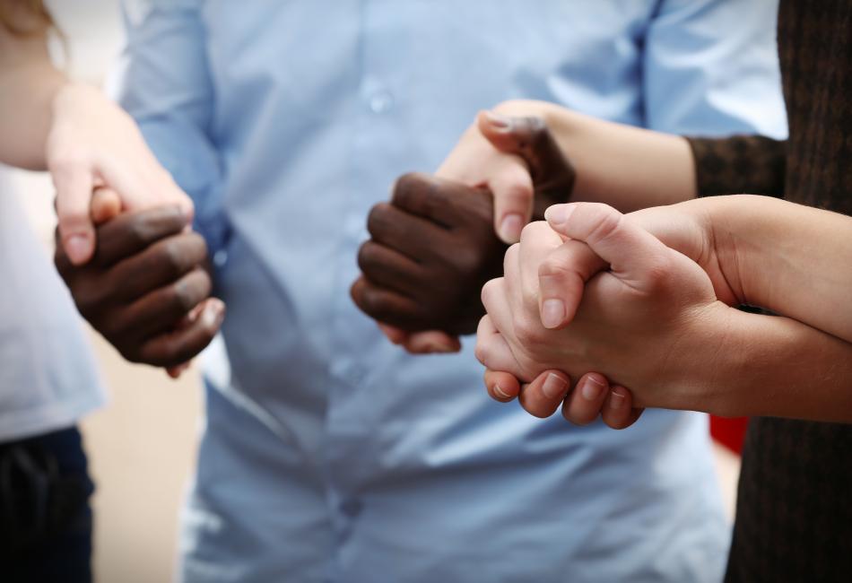 Group of people holding hands